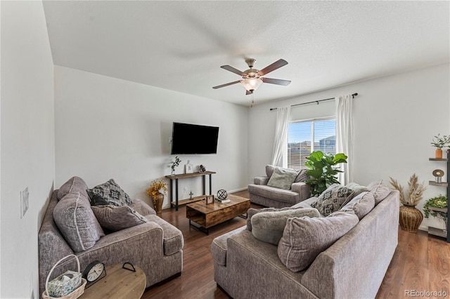 living room featuring a ceiling fan and wood finished floors