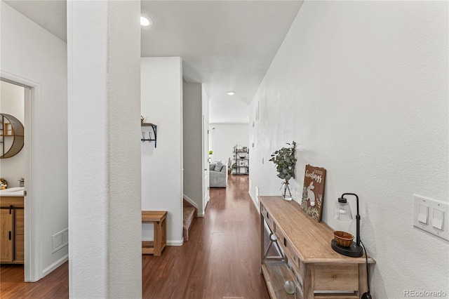 hall featuring recessed lighting, baseboards, visible vents, and wood finished floors