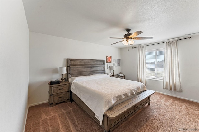 bedroom featuring a ceiling fan, baseboards, visible vents, and dark carpet