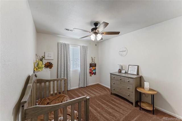 carpeted bedroom with visible vents, a ceiling fan, and baseboards