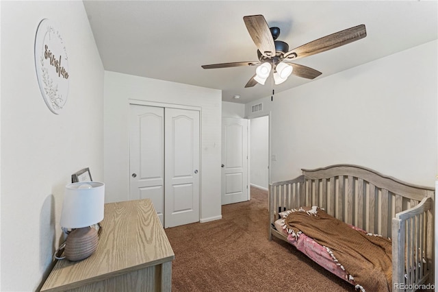 carpeted bedroom with baseboards, ceiling fan, a closet, and visible vents