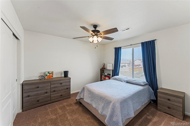 carpeted bedroom featuring baseboards, a ceiling fan, a closet, and visible vents