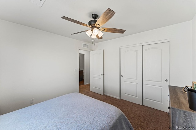 carpeted bedroom featuring visible vents, ceiling fan, and a closet