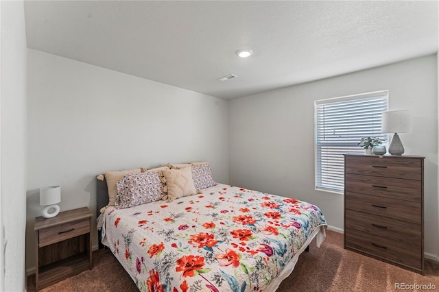 carpeted bedroom featuring baseboards and visible vents