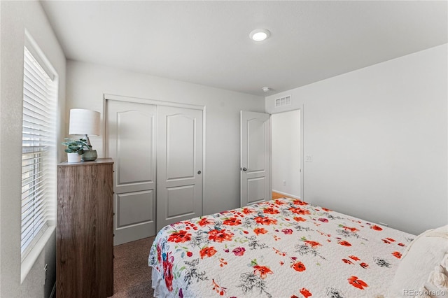 bedroom featuring carpet, a closet, and visible vents