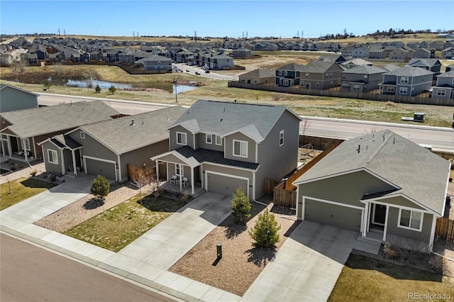birds eye view of property with a residential view and a water view
