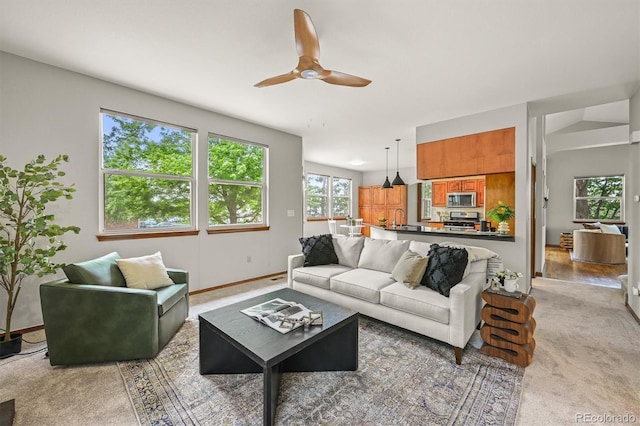 1190 W 11th Ct, Broomfield, CO 80020 - living room featuring a ceiling fan, light carpet, and baseboards
