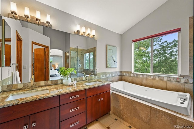 1190 W 11th Ct, Broomfield, CO 80020 - bathroom with vaulted ceiling, double vanity, a garden tub, a stall shower, and ensuite bath