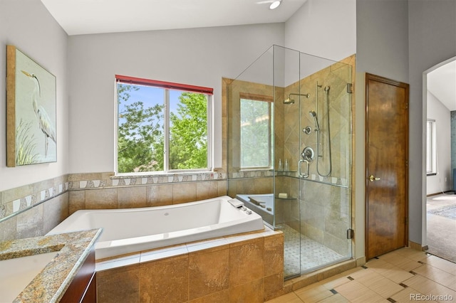 1190 W 11th Ct, Broomfield, CO 80020 - full bath with a garden tub, a stall shower, vanity, lofted ceiling, and tile patterned floors