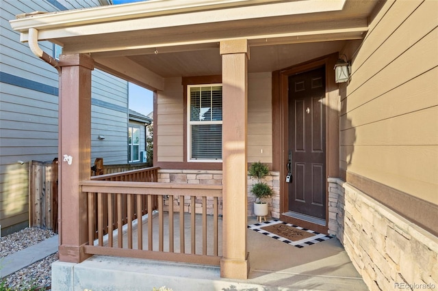 view of exterior entry with a porch