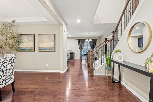 foyer with a notable chandelier and dark wood-type flooring