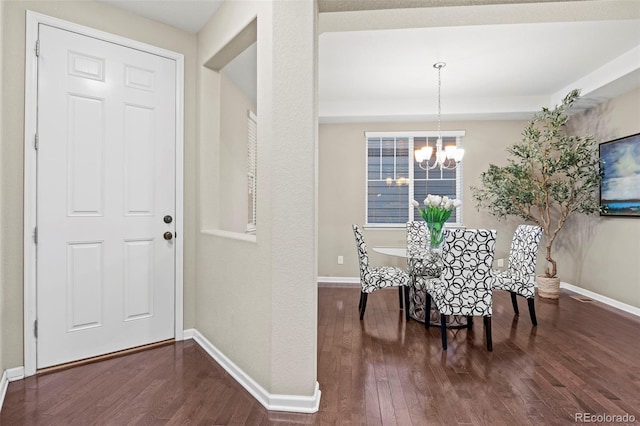 interior space with dark hardwood / wood-style flooring and a notable chandelier