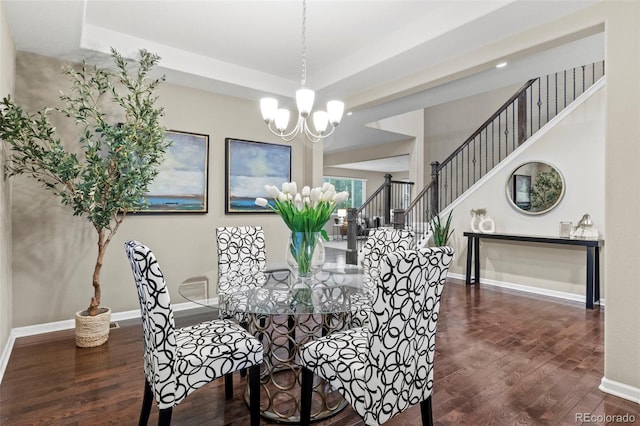 dining room with a notable chandelier and dark hardwood / wood-style floors