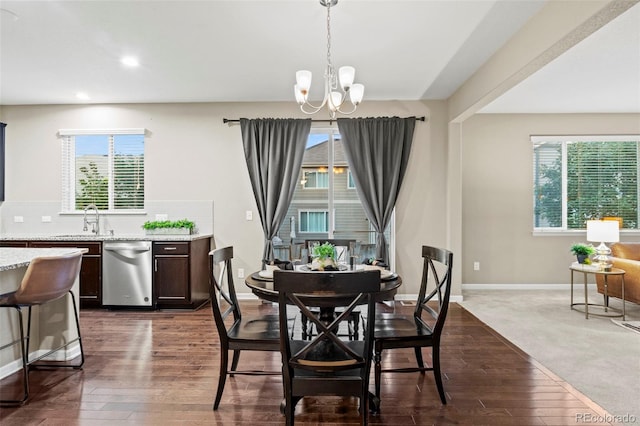 carpeted dining area with a notable chandelier, plenty of natural light, and sink