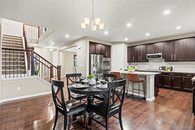 dining room featuring an inviting chandelier and dark hardwood / wood-style floors