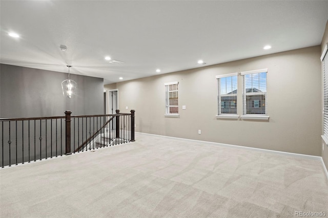 unfurnished room featuring light colored carpet