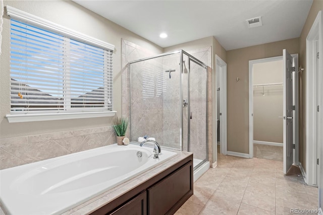 bathroom with plus walk in shower and tile patterned flooring