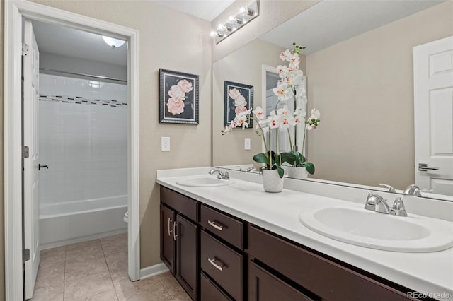 full bathroom featuring tile patterned flooring, tiled shower / bath combo, vanity, and toilet