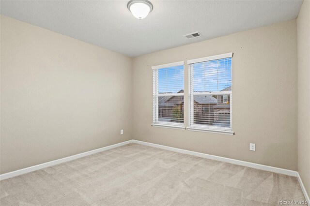 empty room featuring light colored carpet