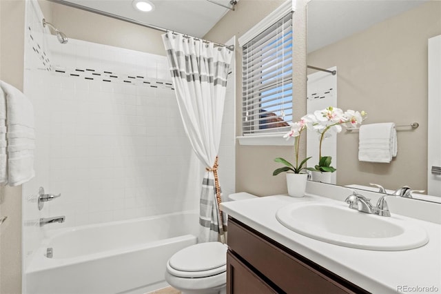 full bathroom featuring vanity, shower / bath combo with shower curtain, and toilet