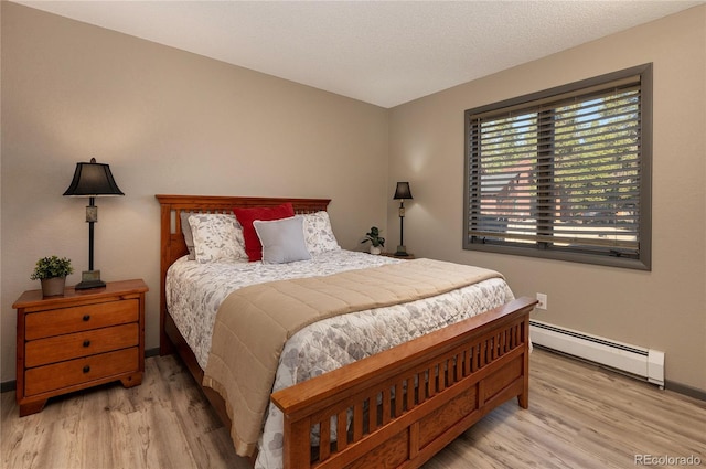 bedroom featuring a baseboard radiator and light hardwood / wood-style floors