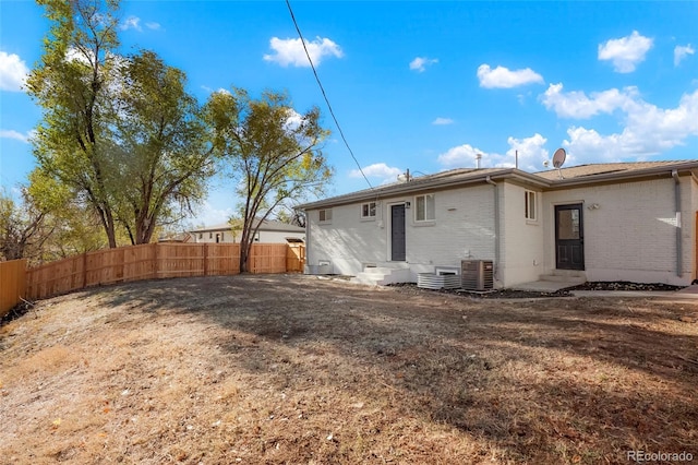 7956 Joan Dr, Denver, CO 80221 - back of house with entry steps, brick siding, and central AC unit