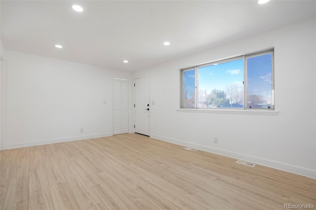 spare room with light hardwood / wood-style floors