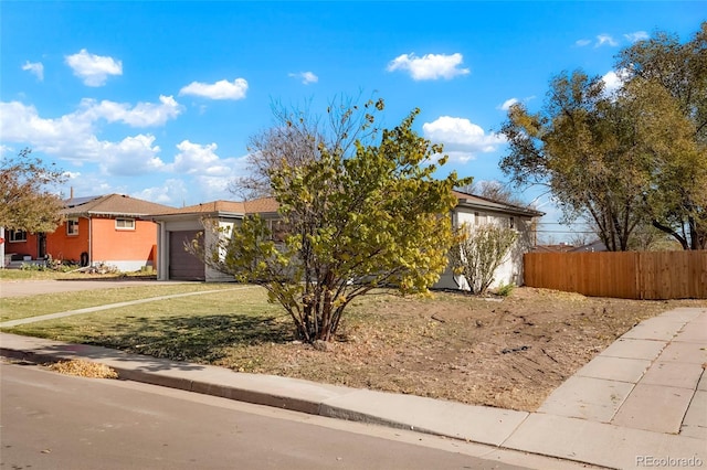 7956 Joan Dr, Denver, CO 80221 - view of front of property with a garage, driveway, and stucco siding