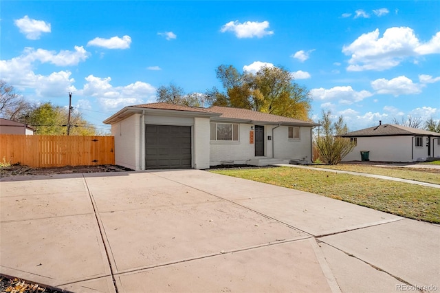 ranch-style home with a front yard and a garage