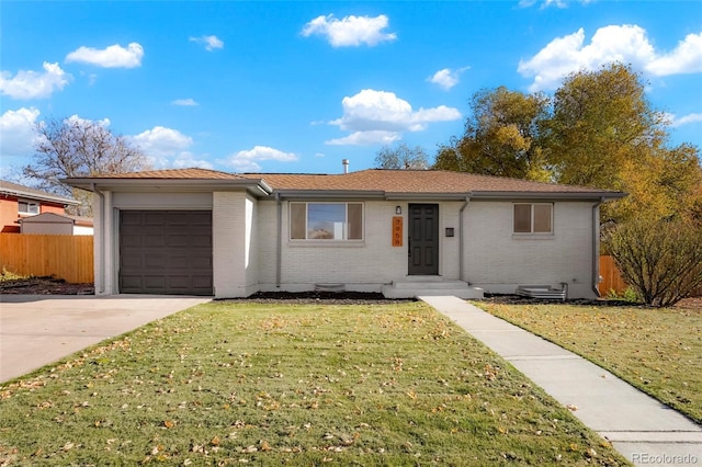 ranch-style house with a garage and a front lawn