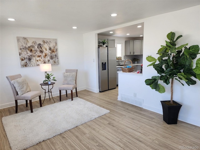 living area with light hardwood / wood-style flooring