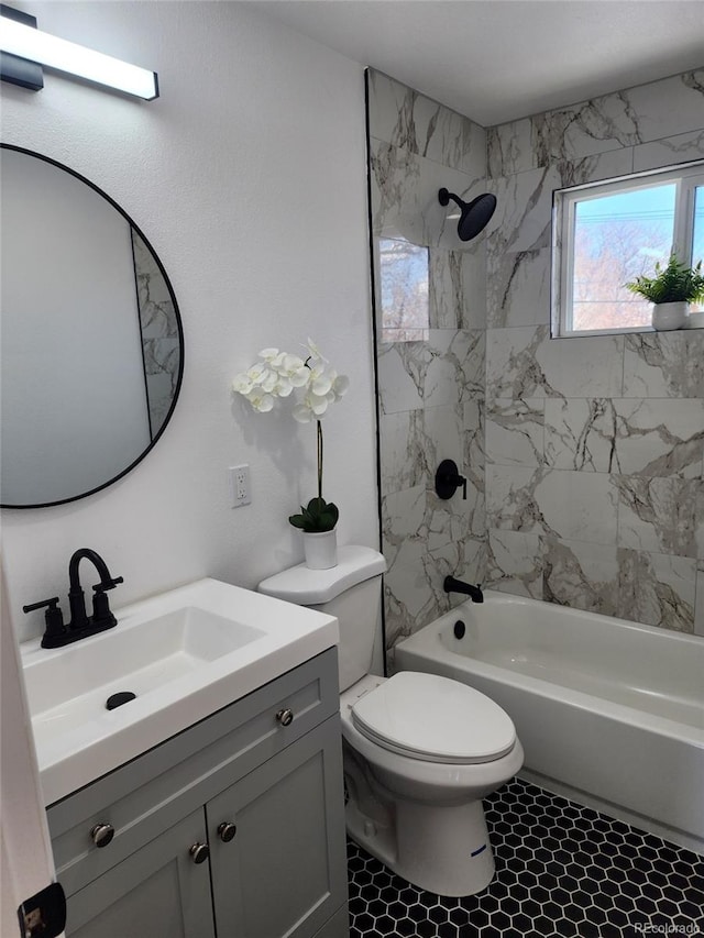 full bathroom with tile patterned flooring, vanity, toilet, and tiled shower / bath