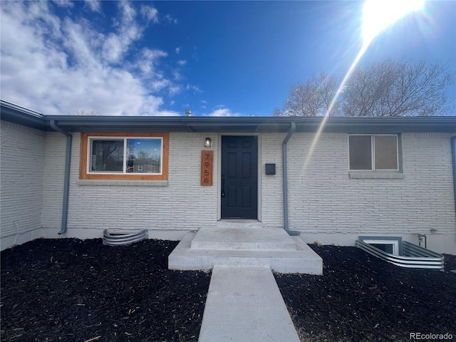 7956 Joan Dr, Denver, CO 80221 - doorway to property featuring brick siding