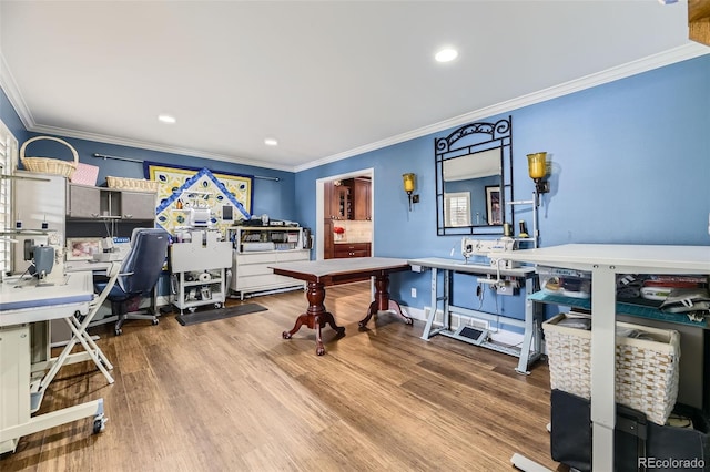 office space featuring ornamental molding, recessed lighting, a workshop area, and wood finished floors