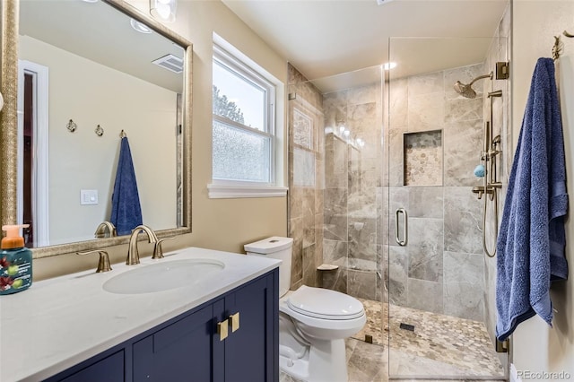 full bathroom with visible vents, a shower stall, toilet, and vanity