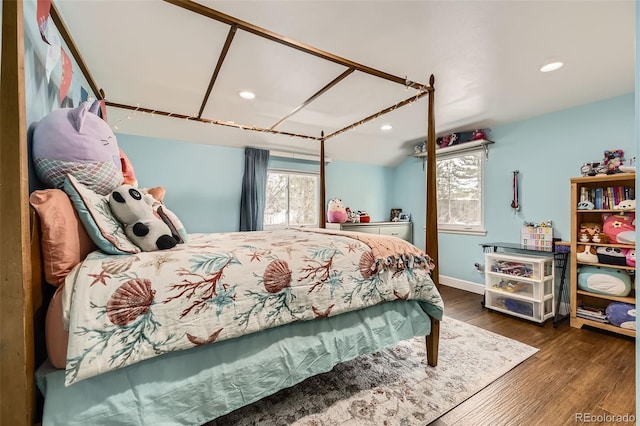 bedroom with lofted ceiling, multiple windows, wood finished floors, and recessed lighting