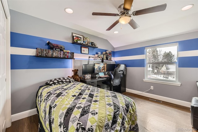 bedroom with vaulted ceiling, recessed lighting, wood finished floors, and baseboards