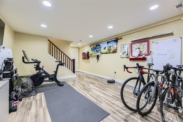 workout area with recessed lighting, visible vents, and wood finished floors