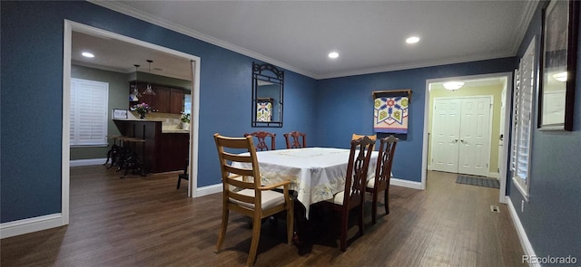 dining room featuring baseboards, dark wood-type flooring, recessed lighting, and crown molding