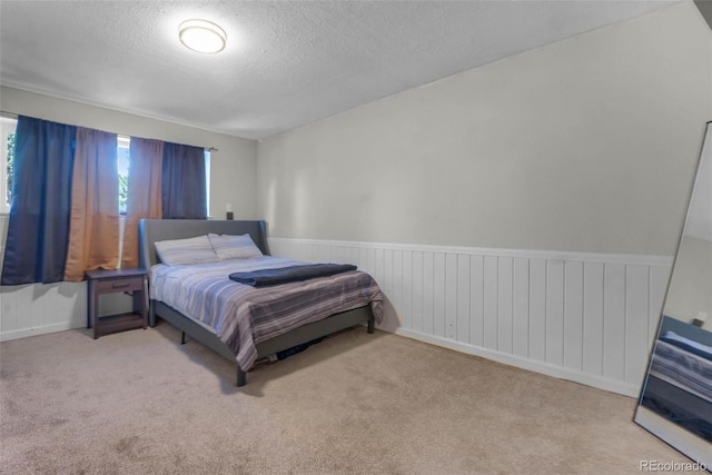 5771 W 92nd Ave Unit 328, Westminster, CO 80031 - carpeted bedroom with a textured ceiling and a wainscoted wall