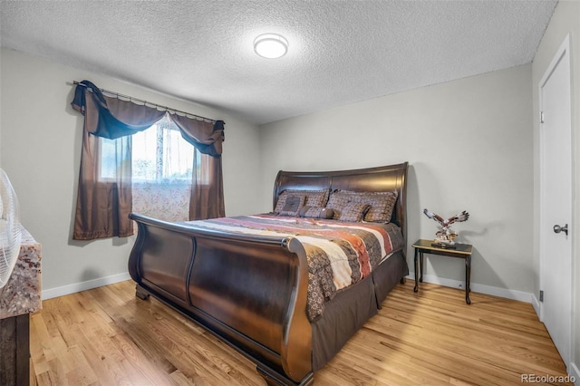 5771 W 92nd Ave Unit 328, Westminster, CO 80031 - bedroom featuring a textured ceiling and wood finished floors