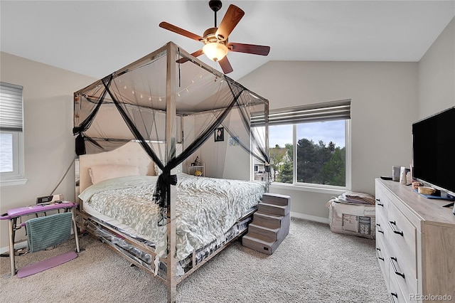 bedroom with vaulted ceiling, ceiling fan, and carpet