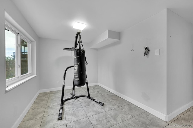 exercise area featuring light tile patterned floors