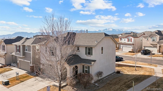 view of side of home with a garage and a mountain view