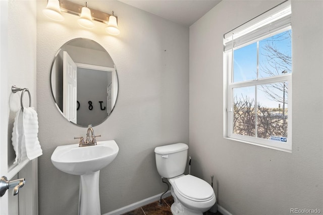 bathroom featuring toilet and tile patterned flooring