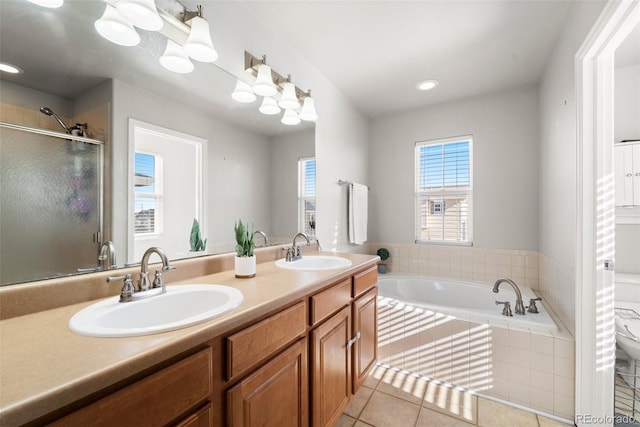 bathroom with tile patterned floors, independent shower and bath, and vanity