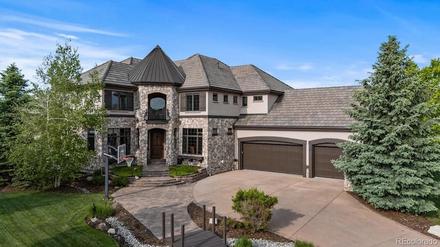 5810 Amber Ridge Dr, Castle Pines, CO 80108 - french country inspired facade with stone siding, a garage, driveway, stucco siding, and a front yard