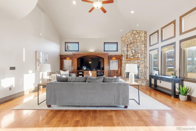 5810 Amber Ridge Dr, Castle Pines, CO 80108 - living area with high vaulted ceiling, a ceiling fan, wood finished floors, and healthy amount of natural light