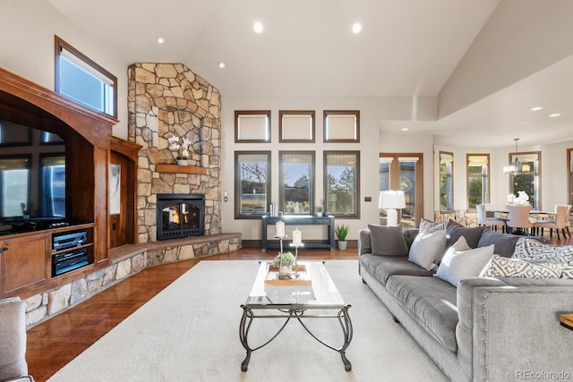 5810 Amber Ridge Dr, Castle Pines, CO 80108 - living room with lofted ceiling, wood finished floors, healthy amount of natural light, a fireplace, and recessed lighting