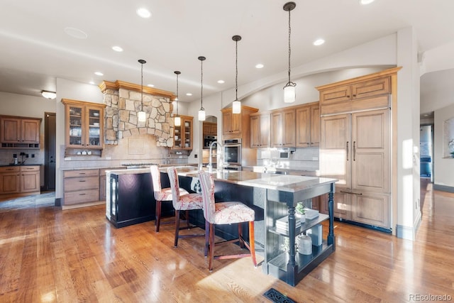 5810 Amber Ridge Dr, Castle Pines, CO 80108 - kitchen featuring paneled fridge, decorative backsplash, a spacious island, recessed lighting, and double oven
